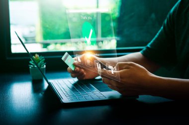 Laptop 'ta Kredi Kartıyla Çevrimiçi Ödeme Yapan Kişi, Holografik Arayüz Ödemenin Başarılı ve Alışveriş Simgelerini Gösteren, E-Ticaret ve Dijital Aktarımları Temsilen