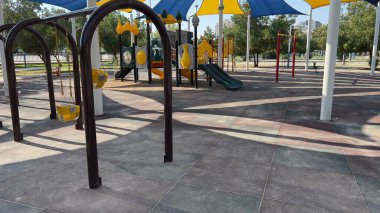 Safe kid's playground with a variety of multicolored attractions. in the sunshine lawn for children. Bright warm sunny morning. in Kuwait
