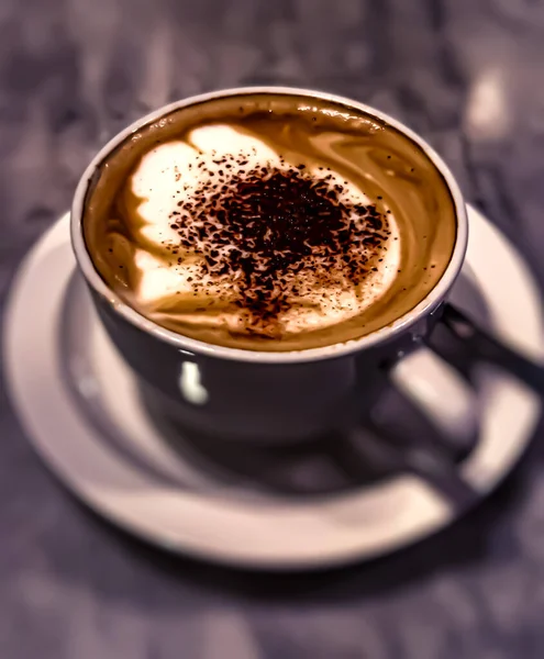 Cup with coffee on white background. Latte art of heart design on coffee. Top view.