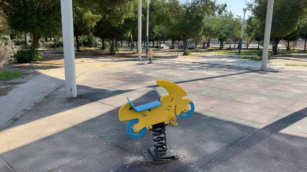 Safe kid's playground with a variety of multicolored attractions. in the sunshine lawn for children. Bright warm sunny morning. in Kuwait