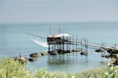 Trabocchi coast. View of the Trabocco Punta le Morge, Ancient fishing machine clipart
