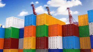 Arka planda odak dışı vinçlerin görüntüsüne sahip renkli konteynırlar.