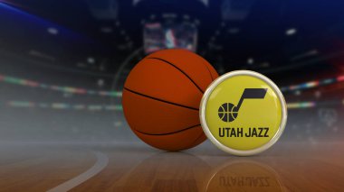 Üzerinde Utah Jazz takımının logosu olan yuvarlak rozet. Arka planda odaklanamadığı bir stadyum olan topun yanında. NBA basketbol takımı.