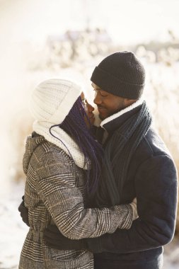 İnsanlar dışarıda yürüyor. Kış günü. Afrikalı çift