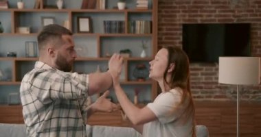 Couple fighting hard hitting each other at home closeup. 4K. Scandal and crisis in family. Domestic violence, abuse.