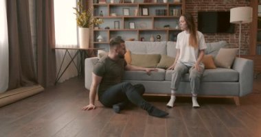 Irritated young woman screams in frustration offends abases her stressed disappointed husband. Domestic violence, abuse.