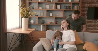 Domestic violence concept. Man and woman fighting in the living room, bruised woman.