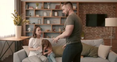 Domestic violence concept. Man and woman fighting in the living room, bruised woman.