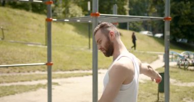 Spor sahasında antrenmandan önce kaslı sporcu vücudunu ısıtıyor. Sporcu spor yapıyor..