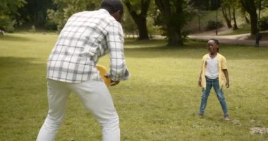 Happy affectionateb lack race family. Father playing with little daughter and walking in the park. Dad and cute child girl enjoy spending time together on outdoor weekend vacation.