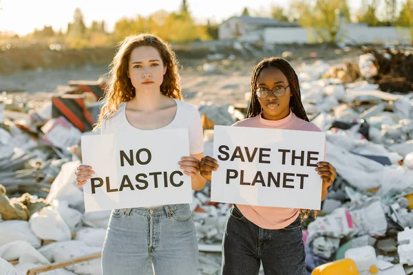 Mixed people are standing with posters SAVE THE PLANET and NO PLASTIC. Concept of environmental pollution and save Earth.
