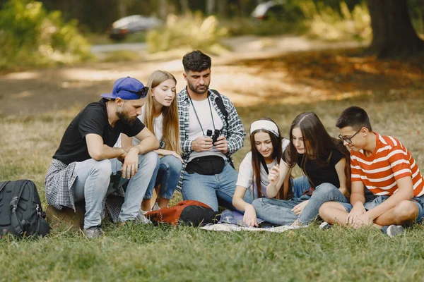 Stock image Adventure, travel, tourism, hike and people concept. Group of smiling friends in a forest.