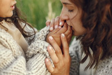 Family in a summer field. Sensual photo. Cute little girl in a knited sweater.