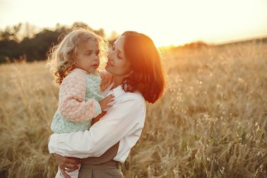 Family in a summer field. Sensual photo. Cute little girl.