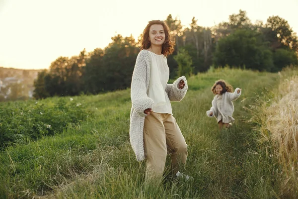 Family in a summer field. Sensual photo. Cute little girl in a knited sweater.