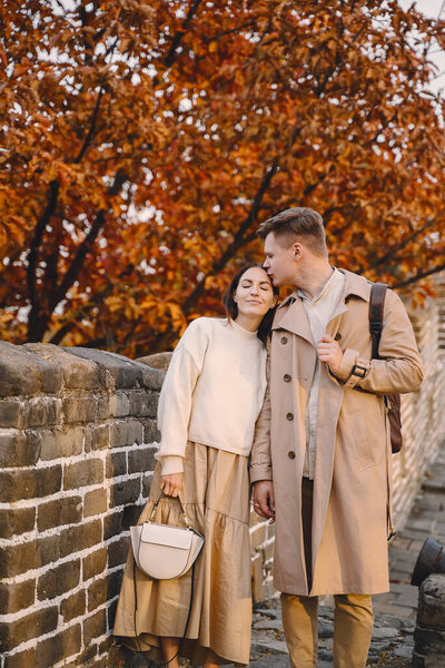 young couple kissing at the Great Wall of China. Newly married couple on their honeymoon to the Great Wall of China near Beijing China.