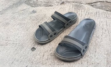 Jakarta, Indonesia - December 7, 2022: worn rubber sandals and one of the straps broke, Jakarta, Indonesia