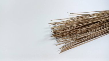 Isolated object: texture of a broomstick made from bones of coconut leaves, on a white background