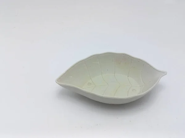 Isolated objects: small leaf-shaped plates usually used for chili sauce, on white background