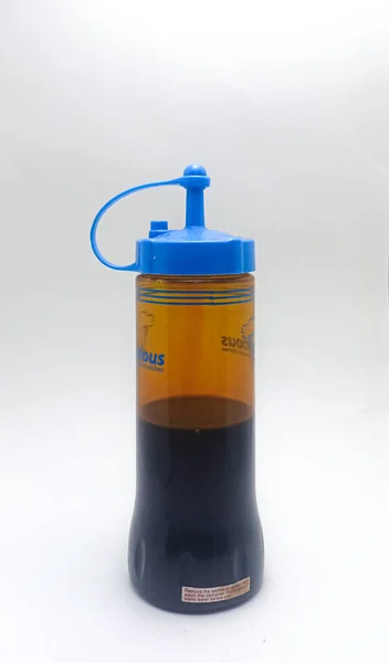 Jakarta, Indonesia - December 13, 2022: Isolated objects: Soy sauce flavoring in plastic bottles, on white background, Jakarta, Indonesia