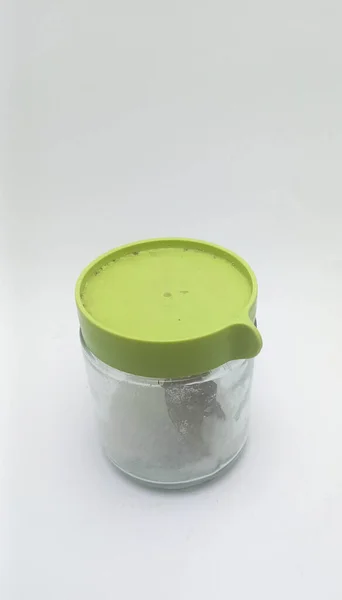 Isolated object: table salt in a glass jar, on a white background