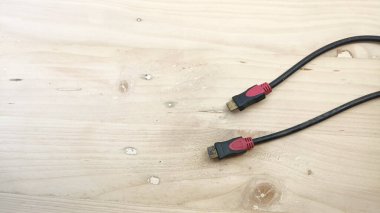 red black HDMI cable with wooden background
