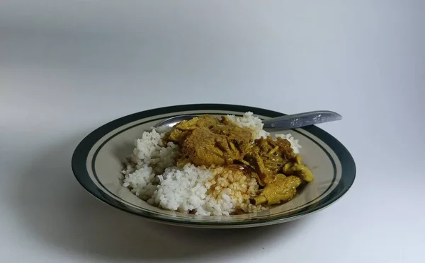 Isolated objects: rice meal with curried chicken, on white background