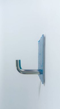 Isolated objects: double-sided tape wall-mounted coat hanger made of stainless steel, on white background