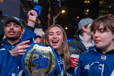 TORONTO, ONTARIO, CANADA - APRIL 20, 2024: fans gather in Maple Leaf Square outside Scotiabank Arena to watch play off game on big screen, Toronto hockey game  clipart