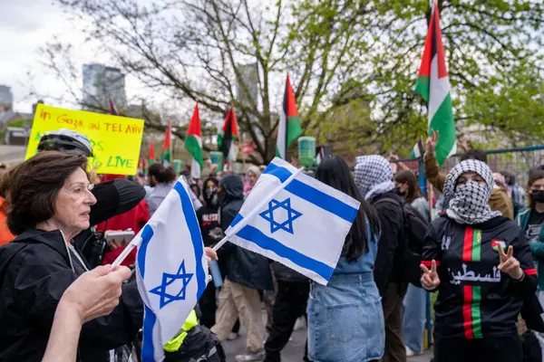 Stock image Canada, Toronto - May 8th, 2024 : pro-Palestinian and pro-Israeli protesters passionately express their views, with intense exchanges outside the student encampment occupying King's College Circle at the University of Toronto