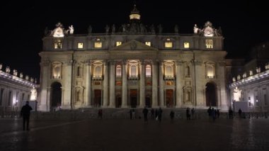 Rome, Italy - December 31, 2022: The facade of St. Peter's basilica illuminated at night. Time-lapse movie.