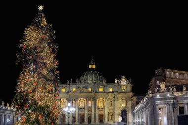 Rome, Italy - December 31, 2022: St. Peter's basilica decorated with Christmas lights and tree. Night scene.