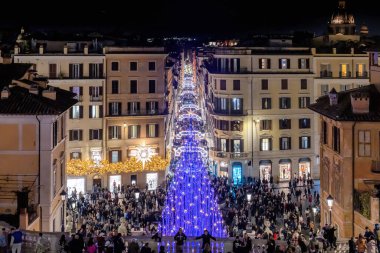 Rome, Italy - December 26, 2022: Crowd in the Spanish Steps and Via Condotti, in the historic center of the city, a lot of people stroll in the street for Christmas shopping and for tourism.