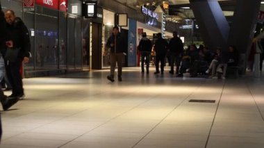 Naples, Italy - January 3, 2023: Inside the central Naples railway station, travelers move around walking with suitcases in the direction of the departure platform.