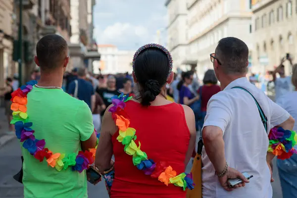 stock image Rome, Italy - June 10, 2023: The great Gay Pride parade through the streets of the capital to demonstrate LGBTQ+ pride. In the photo some participants wear a garland of colored flowers. 