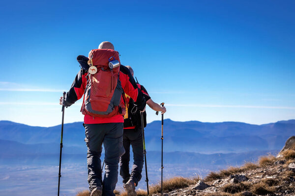 Two hikers reach the summit of Monte Tino (1923 m above sea level), in Abruzzo, Italy.