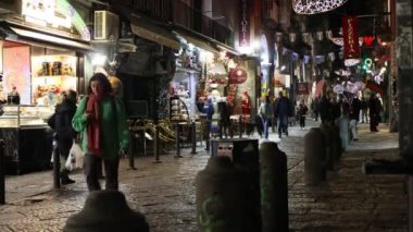 Napoli, İtalya - 12 Aralık 2024: Via dei Tribunali, şehrin tarihi merkezinde, Noel tatilleri boyunca turistik bir yer olan gece aydınlandı.