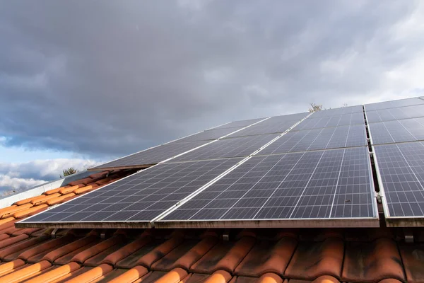 Photovoltaic modules in front of blue and cloudy autumn sky. High quality photo