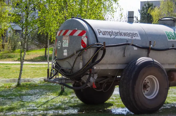 Büyük ve etkileyici bir tanker kamyonu uçsuz bucaksız çimenli bir araziye park edilmiş doğal arka planda önemli varlığını sergiliyor.