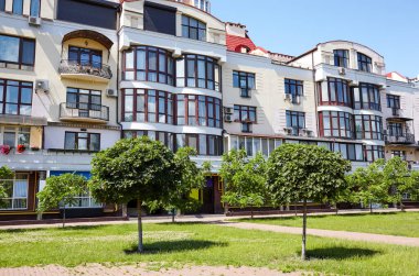 Mavi gökyüzü olan güneşli bir günde modern apartman binaları. Ukrayna 'nın başkenti Kyiv' de modern bir Avrupa apartmanı. Soyut mimari, modern şehir geometrisinin bir parçası