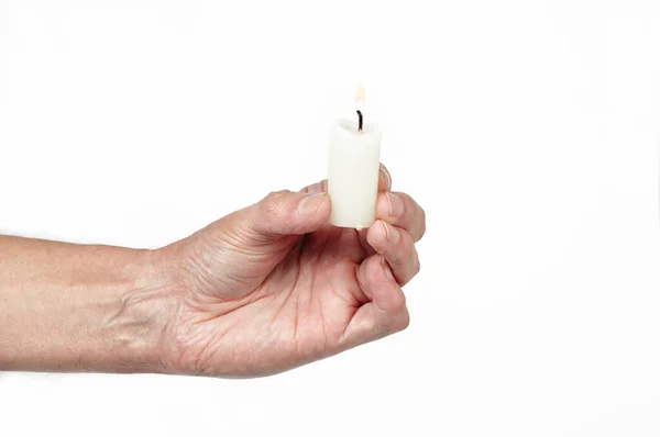 Men\'s hand holding a candle isolated white background. Man holding burning candle, closeup