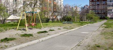 Bahçede çocuksuz renkli salıncaklar. Kentsel mahalle çocukluk kavramı