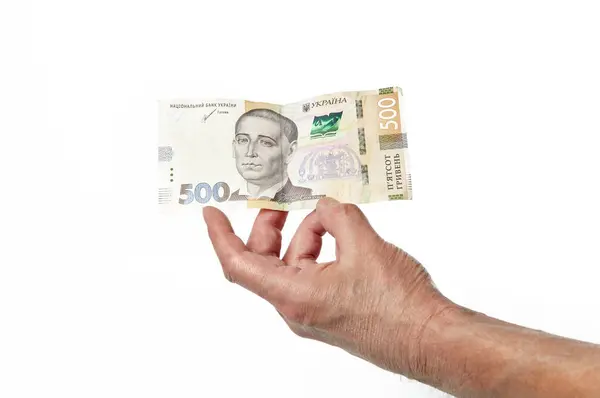 Beyaz arka planda izole edilmiş Ukrayna para birimiyle el ele tutuşan erkekler. 500 Hryvnia banknotu.