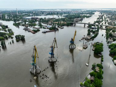 Undermining the dam of the Kakhovka reservoir. Consequences of the dam blowing. Flooded port infrastructure of the city of Kherson. Top view from above, aerial footage. Russian-Ukrainian war clipart