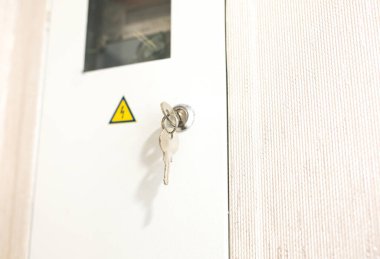 Electrical breaker panel in the flat. Danger sign. Renovation indoors.