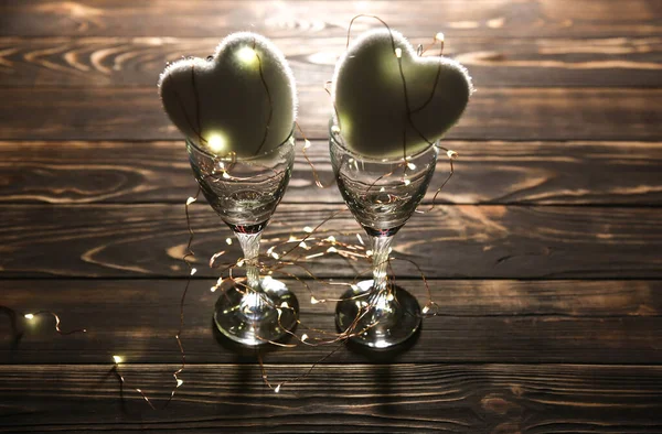 Hearts with wine glasses. Romantics love concept. Festive background. Valentines day postcard. Lights and lamps.