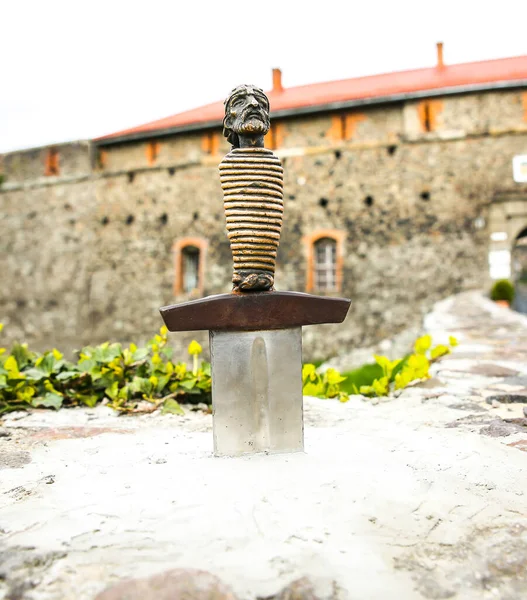 stock image Sword in the stone near the castle. Saint Arthur's style medieval period. Middle ages photo. Old walls and weapon. Ancient history in details.