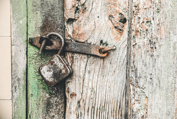 Old wooden doors with lock. Weathered texture background.