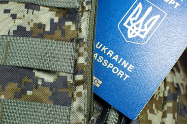 Ukrainian biometric passport on the military backpack. Ukrainian soldiers. Army concept. Stop war.