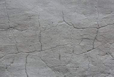 Concrete wall with a crack on it. Grey texture background.